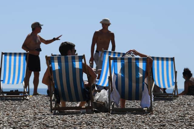 People sunbathe on Brighton Beach.