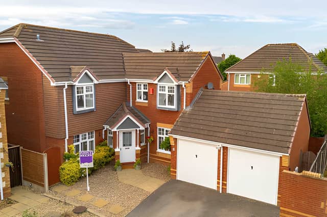 The detached home sits in a quiet cul-de-sac, with off-road parking and a double garage