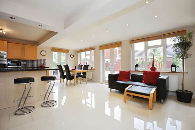 The large living room is complemented by a second sitting room and formal dining room