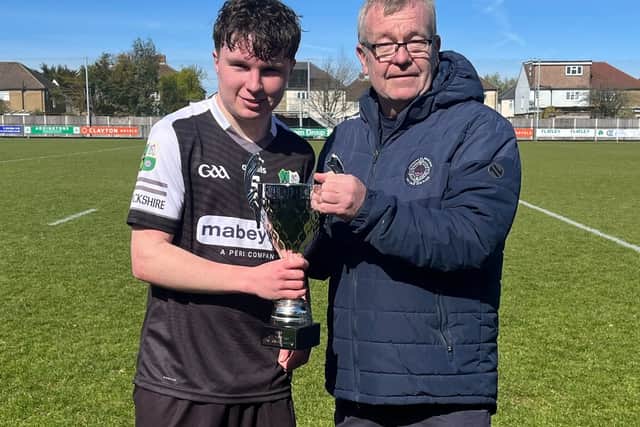 Captain Ryan Brough receives the U17 All Britain trophy from Michael Collins, vice president Britain GAA.