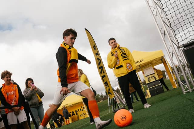 A young Rugby Borough player takes his shot in the Beat the Robokeeper challenge in the STANLEY® fan zone.