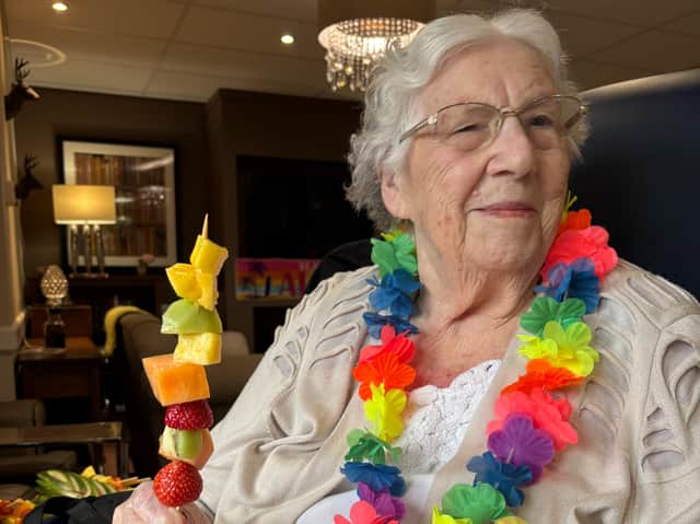 Residents at Cubbington Mill's tropical themed open day enjoying their fruit kebabs