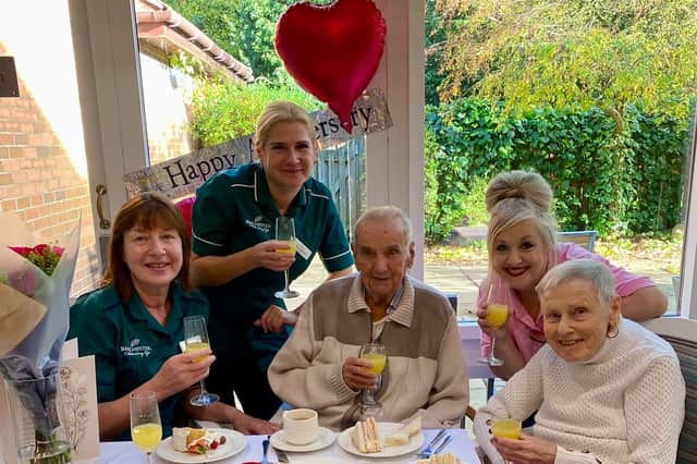staff and family at Overslade House Care Home celebrate with Don and Jenny