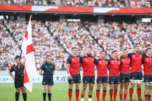 Izzy standing alongside the England team in the Toyko stadium for the national anthems
