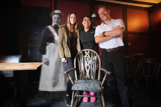 Julia Correderas Orozco; Sweetie Sohal and Alex Clayton are joined for the
photo by a ghostly guest at the haunted rocking chair. Photo by Soft Focus Productions.