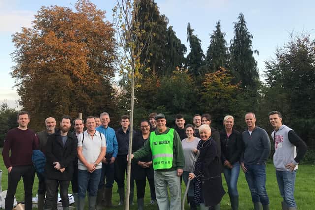 Photo shows Tree Warden, Stuart Powney, Company Director, Mark Radley and the team with their newly planted elm tree.