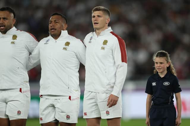 Freya Berry stands next to England's Owen Farrell during the national anthem.  (Photo by David Ramos - World Rugby/World Rugby via Getty Images)