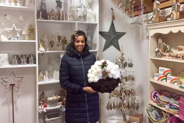 Naomi Weetman holding one of the handcrafted wreaths she made at the F. Weetman and Sons Christmas Shop and Farm