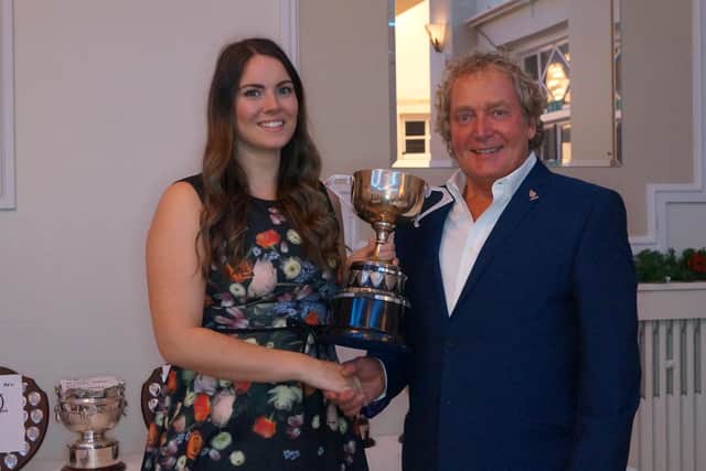 Claire Walker receives one of her trophies from club chairman Martin Orrill