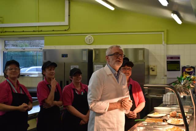 Mr Corbyn joins catering staff at Bilton School on the day the party proposes to bring free, healthy meals to far more schoolchildren.