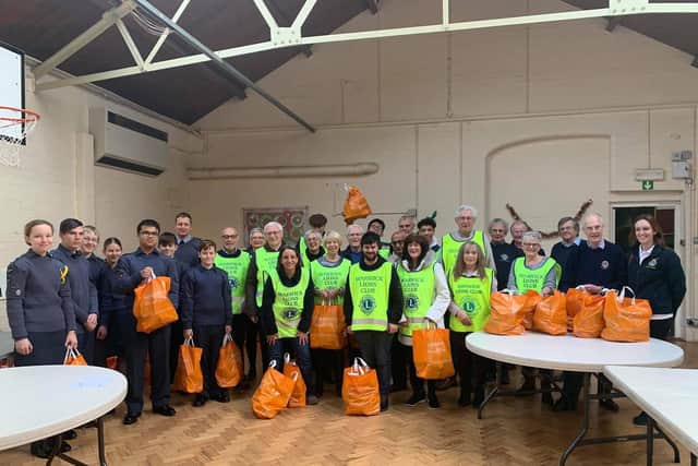 Members of the Warwick Lions Club, members of No. 1368 Squadron Air Training Corps and other helpers making up the food parcels. Photo submitted.
