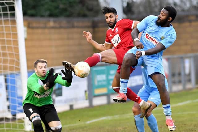Danico Johnson challenges in the box in Rugby Town's 4-0 win over Oadby  Picture by Martin Pulley