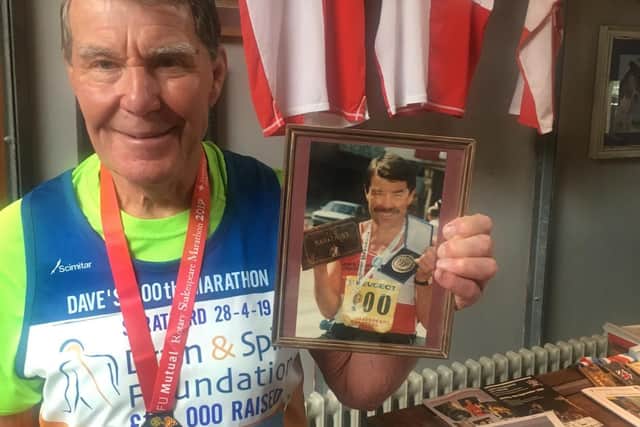 David holds a picture of himself photographed after his first marathon