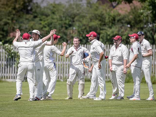 Oakfield & Rowlands 1st XI celebrating in a game last summer