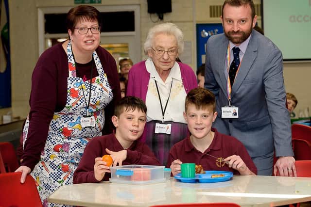Lunchtime supervisor, Maxine Tabour, who will be 80 this year, has worked St Paul's School in Leamington for 50 years. Pictured: Linda Tabour (Daughter In Law), Maxine Tabour, Matthew Bown (Headteacher) together with pupils.