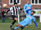 Assistant manager Justin Marsden slides into a tackle