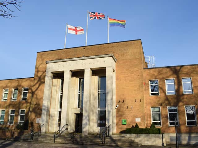 The rainbow flag flies at the town hall.