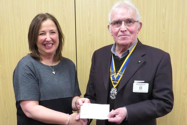 Warwick Rotary President David Brain presented Rachel Ollerenshaw with a cheque towards her work. Photo supplied.