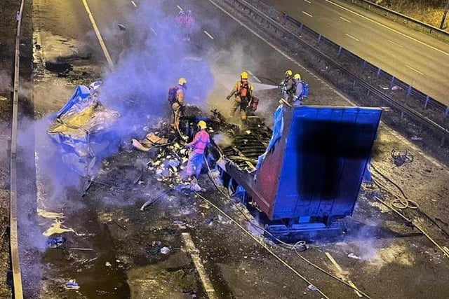 The M6 was shut both ways between junctions 27 (Standish) and 28 (Leyland) after the crash at 4.50am.
Police said strong winds caused a lorry to hit a motorway bridge before 'bursting into flames'.
In one picture, fire crews can be seen tackling the fire, with the lorry and its trailer nearly destroyed by the blaze.
Fortunately, the driver managed to escape from the burning cab with help from other motorists.
He suffered a head injury and was taken to hospital by ambulance, but his injuries were not thought to be serious.