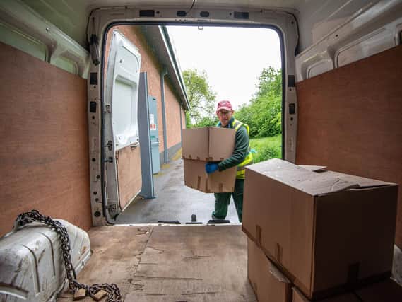 Matt Holt loads a van with supply boxes for the borough's shielding residents.