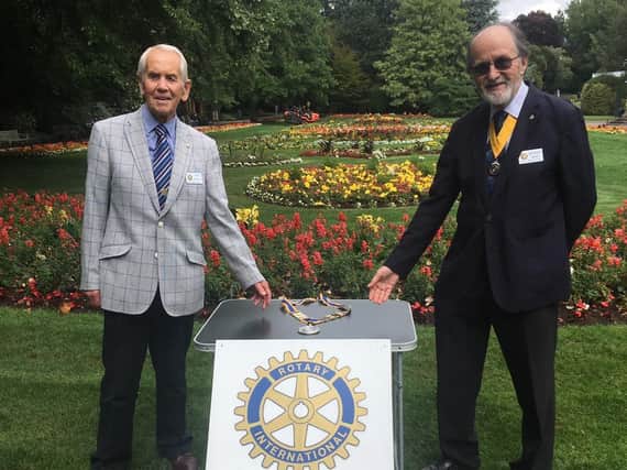 OutgoingnRoyal Leamington Spa Rotary Club President Colin Robertson, on the left, is pictured carrying out a socially distanced handover of the chain of office to incoming President Michael Heath.