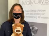 Rachel Ollerenshaw wearing one of the masks and holding Olly the Brave.  Photo supplied