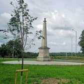 Newly-planted saplings complement the lime trees on the island at the memorial.