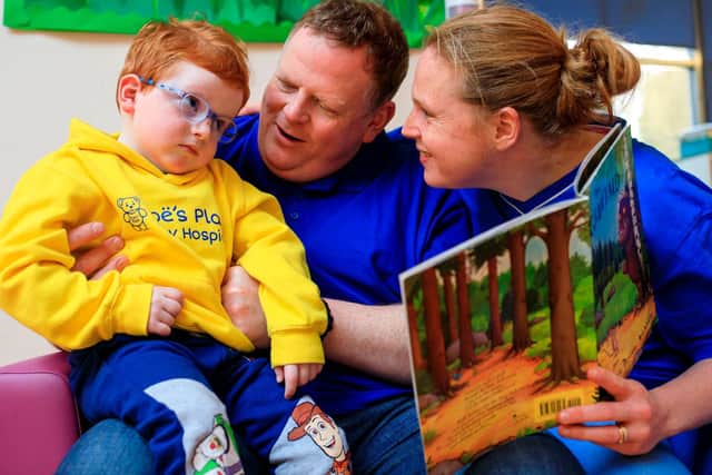 Laura and James Maclellan reading with Ethan. Photo supplied