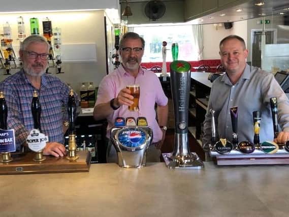 Rugby MP Mark Pawsey (centre) pulls a pint with David Hine, Fighting Cocks publican (left) and Julian Searle, , regional manager for the EI Group (right).