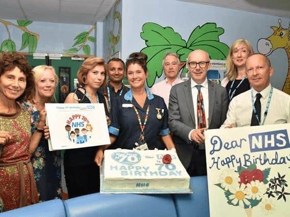 Matt Western celebrates the 70th birthday of the NHS with staff.