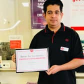 Postmaster Amjad Ali with his well-deserved award.
