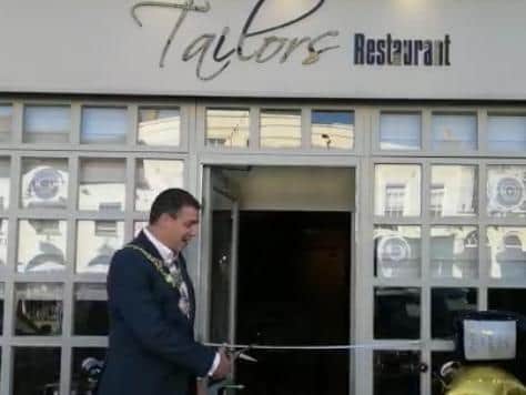 The Mayor cutting the tape with tailors scissors. Photo supplied
