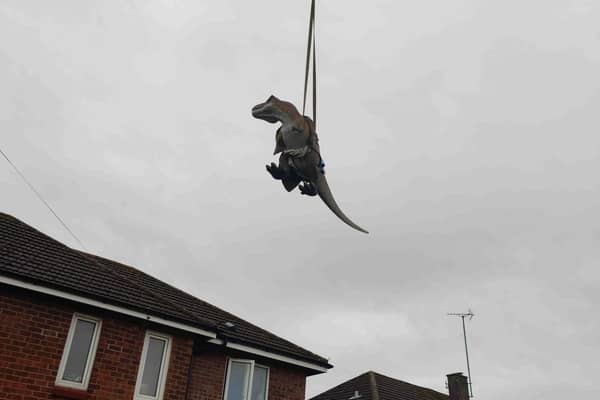 The T-Rex was lifted into the garden by a crane.