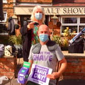 Sue Middleditch shaves Mark Charnock's head as part of the 'Brave the Shave' fundraising challenge held to help Macmillan Cancer Support