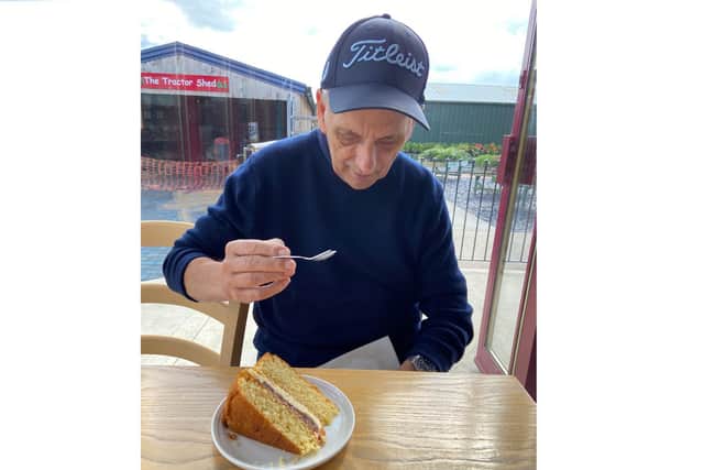 Kenneth enjoying a slice of cake.