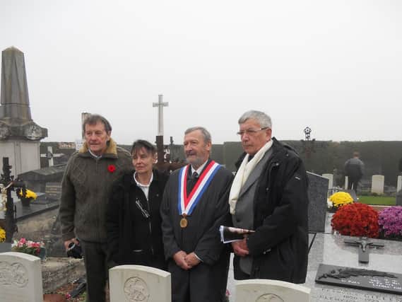 Thomas White of Warwick, left, stands behind his father’s grave at
Wormhoudt cemetery, together with French dignitaries.