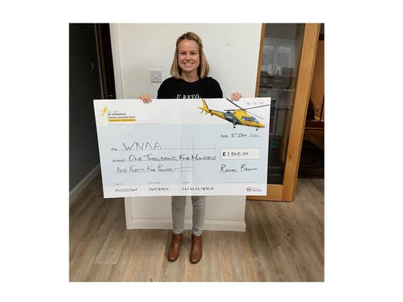 Rachel Brown hands over the cheque to the Warwickshire and Northamptonshire Air Ambulance.