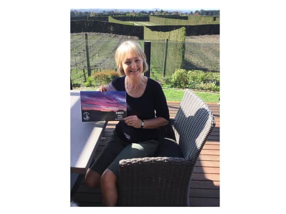 Julie Brisby with her Abbey Fields calendar in New Zealand.