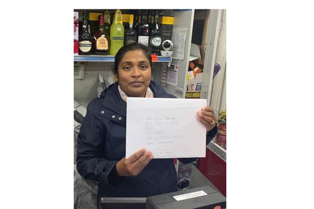 Suthar Rajkumar, who runs Fieldgate Post Office, with the calendar ready to go to New Zealand.