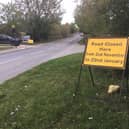 A road closure sign posted on the roadside for Warwick Road at the junction of Brookhampton Lane, which is a major through road for the village.