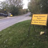 A road closure sign posted on the roadside for Warwick Road at the junction of Brookhampton Lane, which is a major through road for the village.