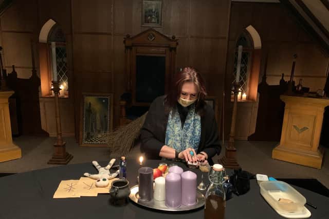 Penny West the Wiccan Witch lighting candles. Photo by Really