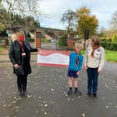 Louise Careless of The Myton Hospices accepts a cheque for £210 from Milo Braley and Sharon Turnbull of The 1st North Leamington Spa Beavers group.
