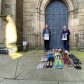 Councillor Andy Crump, Warwickshire County Councils Portfolio Holder for Fire & Rescue and Community Safety and Warwickshire Police and Crime Commissioner Philip Seccombe promote the event outside St Marys Church in Warwick. Each of the pairs of shoes at the front represent a road death victim from Warwickshire during 2019/20.