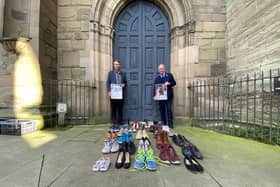 Councillor Andy Crump, Warwickshire County Councils Portfolio Holder for Fire & Rescue and Community Safety and Warwickshire Police and Crime Commissioner Philip Seccombe promote the event outside St Marys Church in Warwick. Each of the pairs of shoes at the front represent a road death victim from Warwickshire during 2019/20.