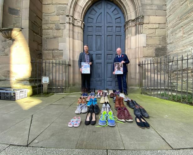 Councillor Andy Crump, Warwickshire County Councils Portfolio Holder for Fire & Rescue and Community Safety and Warwickshire Police and Crime Commissioner Philip Seccombe promote the event outside St Marys Church in Warwick. Each of the pairs of shoes at the front represent a road death victim from Warwickshire during 2019/20.