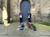 Councillor Andy Crump, Warwickshire County Councils Portfolio Holder for Fire & Rescue and Community Safety and Warwickshire Police and Crime Commissioner Philip Seccombe promote the event outside St Marys Church in Warwick. Each of the pairs of shoes at the front represent a road death victim from Warwickshire during 2019/20.