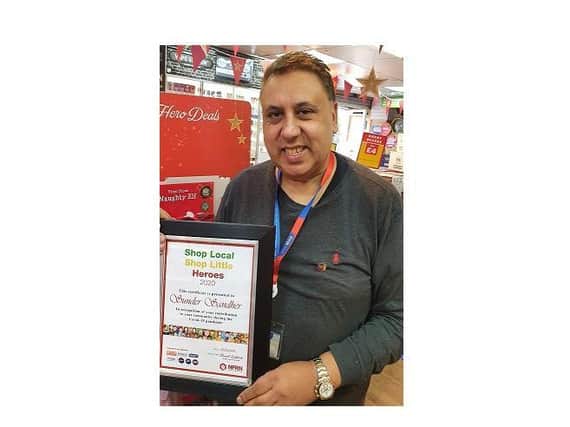 Sunder Sandher with his award from The National Federation of Retail Newsagents.