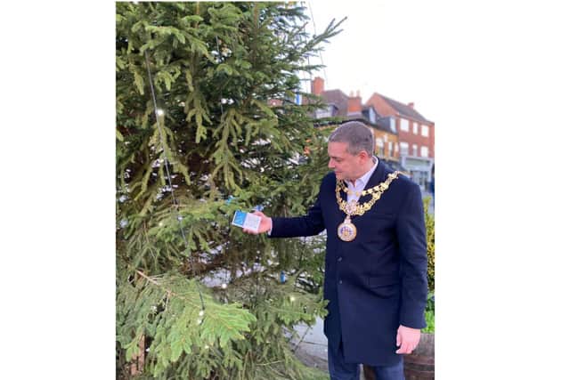 Warwick Mayor, Cllr Terry Morris, putting the first card on the Christmas tree in Market Place. Photo supplied