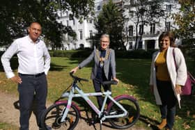 Leamington Mayor Cllr Susan Rasmussen receives her electric bike from Lash Saranna, chief executive officer of Electric Zoo.